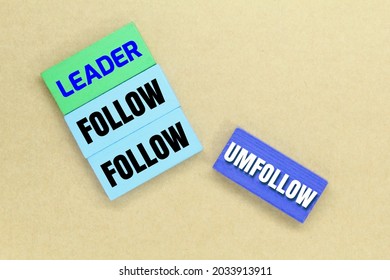 colored boards with the words follow leader and unfollow