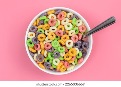 Colored breakfast cereal in a bowl on a pink background, flat lay, children's healthy breakfast, close up. - Powered by Shutterstock