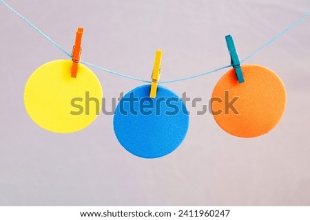 Colored circles attached to string with clothespins