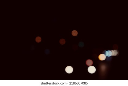 Colored Circles Bokeh Of Car Lights At Black Dark Night In City. Blurry Abstract Texture Background.