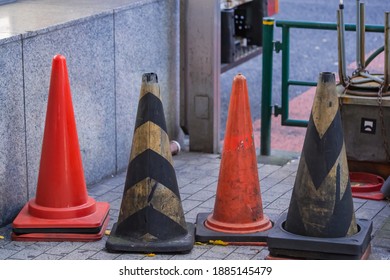 Colored Cones On A Sidewalk In A Busy Shopping District In Shinjuku, Tokyo.