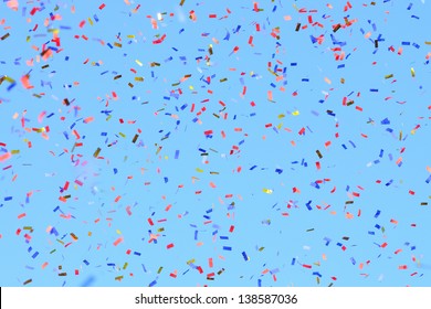 Colored Confetti Flying In The Blue Sky. Are Small Pieces Or Streamers Of Paper, Mylar, Or Metallic Material Which Are Thrown At Parades And Celebrations.