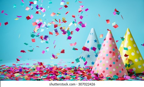 Colored confetti and party hat on blue background