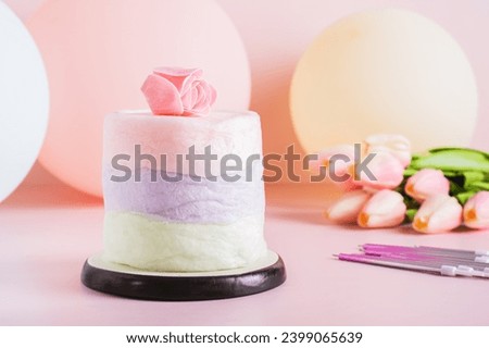 Colored cotton candy cake and party decorations on the table
