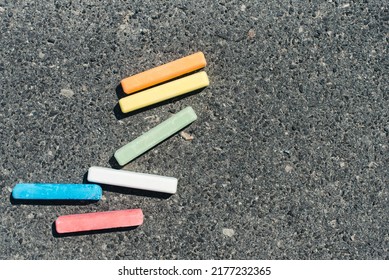 Colored crayons on the pavement. Children's crayons for drawing.