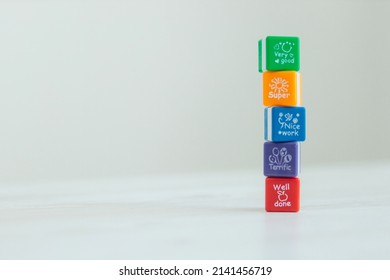 Colored cubes with different words. The process of success. Well done very good. nice work. super. terrifc. place for your text