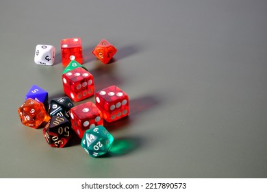 Colored Dice On A Green Table.