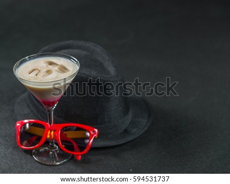 colored drink, a combination of red, beige and violet, martini glass, red sunglasses, black stylish hat, party set