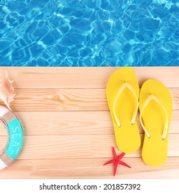 Colored Flip Flops On Wooden Platform Beside Sea