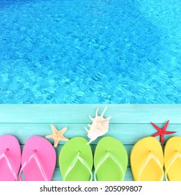 Colored Flip Flops On Wooden Platform Beside Sea