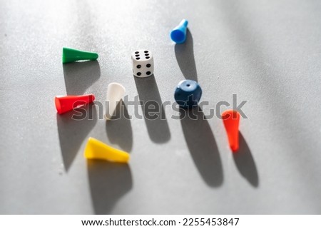 Colored game chips and playing cubes laid out on a gray background. entertainment, games at home for the whole family, the concept of board games. Board game. Table games