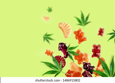 Colored Gummies Fly Along With Cannabis Leaves. Chewing Candies, Gummies With CBD Oil And THC. Colorful Creative Background, Minimalism.