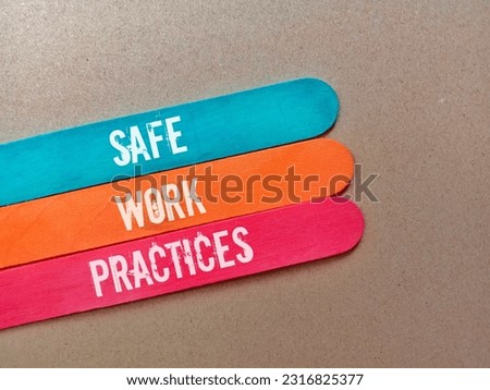 Colored ice cream sticks with the words safe work practices on a brown background.

