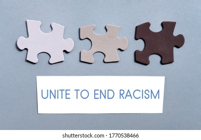 Colored Jigsaw Puzzle pieces on gray background top view. Concept for Unite to end racism, All colors are beautiful, diversity, equality, Unity, No to racism, COLOURS, UNITE against racism, TALERANCE.