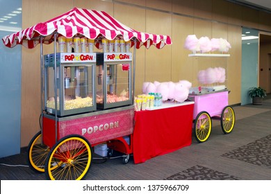 Colored kiosk selling popcorn and cotton candy in the building