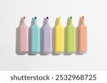 Colored markers pens on a white background. Top view, flat lay.