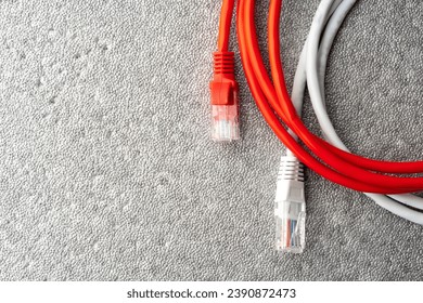 Colored network cable patch-cord on gray textured background