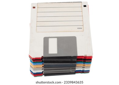 Colored old retro floppy diskettes in stack. Isolated on white background.
