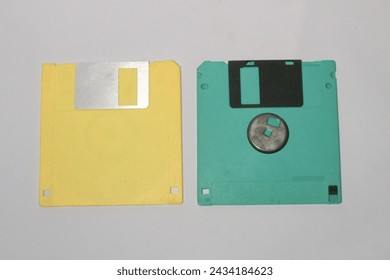 Colored old retro floppy diskettes in stack. Isolated on white background.