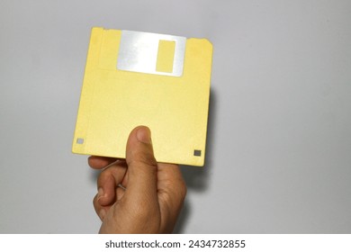 Colored old retro floppy diskettes in stack. Isolated on white background.