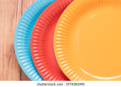 Colored Paper Barbecue Plates On Wooden Background