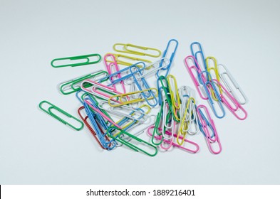 Colored Paper Clips Lie On The Table.