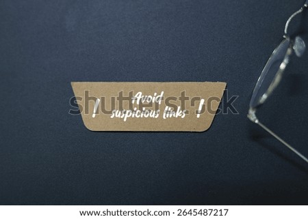 colored paper with the words Avoid suspicious links. relates back to the dangers of a potential cyber-attack, specifically a phishing