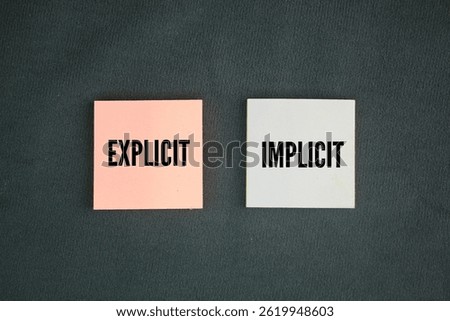 Colored paper with the words explicit and implicit. motivational words positive and negative