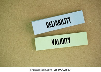 Colored paper with the words reliability and validity. Reliability refers to the consistency of a measure, while validity refers to the accuracy of a measure.
