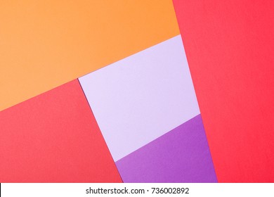Colored papers geometry flat composition background with violet,red, lilac, orange.
