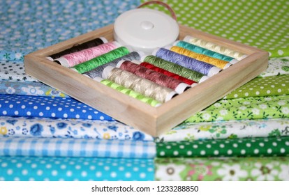 colored patchwork fabrics with threads and needles
