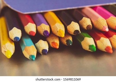 colored pencils in a box on the table