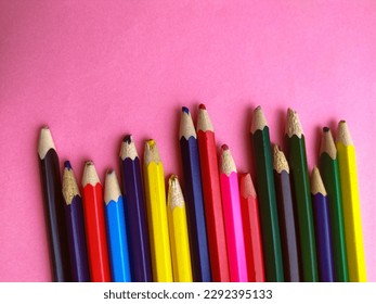 Colored pencils are broken on a pink background. Many different colored pencils. Colored pencil. The pencils are broken. Pencils and a sharpener. Creation. Hobby. Close-up. Copy space. Flat lay - Powered by Shutterstock