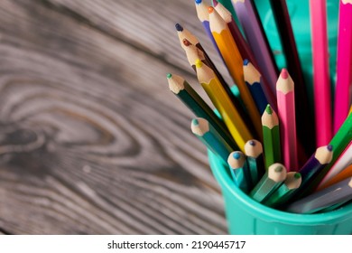 Colored Pencils For Drawing.  They Stand In A Pencil Holder In The Form Of A Trash Can. On Pine Boards.  Close-up.