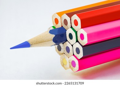 Colored pencils, ends are not sharpened, blue pencil sharpener, on white background, selective focus - Shutterstock ID 2265131709