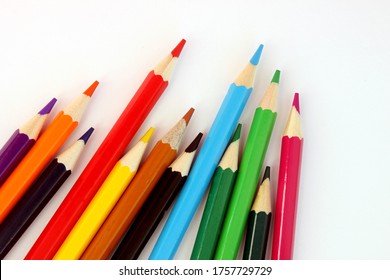 Colored pencils on a white background. Lots of different colored pencils. Colorful pencil. Pencils are sharp. Pencils lie diagonally in the lower left corner. Close-up. Copy space. Background. - Powered by Shutterstock