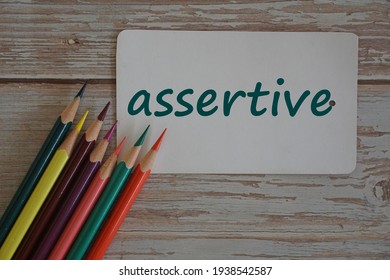 colored pencils with word assertive - Shutterstock ID 1938542587