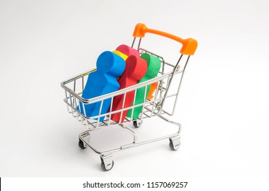 Colored People In A Trolley For A Supermarket. Concept Of Human Trafficking, Modern Slavery. Buying People Is A Violation Of International Laws. Freedom And Respect For Human Rights.