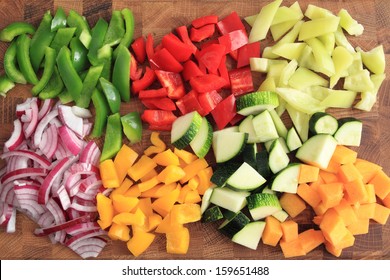 Colored peppers and onions diced on a chopping board
