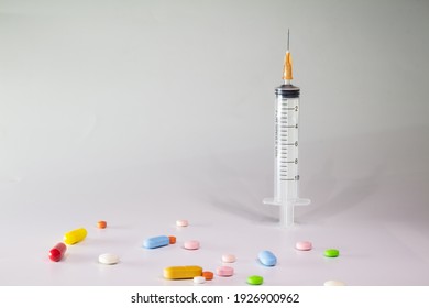 Colored Pills On A White Background With Free Space To Write. Subcutaneous Needle Syringe. Concept Of Legal Drug Use For Human.