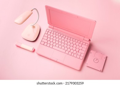 Colored PinColored Pink Laptop With Bright Floppy Disk, Modernity Concept.k Laptop With Bright Floppy Disk, Modernity Concept. High Quality Photo