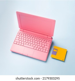 Colored PinColored Pink Laptop With Bright Floppy Disk, Modernity Concept.k Laptop With Bright Floppy Disk, Modernity Concept. High Quality Photo