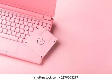 Colored PinColored Pink Laptop With Bright Floppy Disk, Modernity Concept.k Laptop With Bright Floppy Disk, Modernity Concept. High Quality Photo