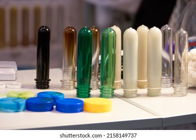 Colored Plastic Bottle Pet Preforms And Caps. Flasks For Blow Molding, Filling And Labeling, Bottle Production.