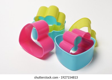 Colored Plastic Cookie Cutters On White Background