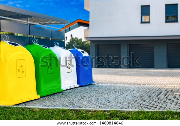 Colored plastic trash cans . Large\
wheelie bins . Urban recycling waste and garbage\
services