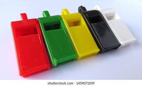  colored plastic whistles are cheap, usually used by parking attendants, scouts, schoolchildren                               - Powered by Shutterstock