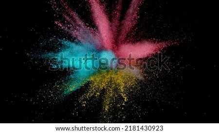 Colored powder explosion. Abstract closeup dust on backdrop. Colorful explode. Paint holi.