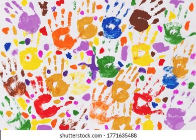 Colored prints of children's hands on a white canvas. A child's handprint on paper. Colored handprints. Many children's multi-colored handprints - Powered by Shutterstock