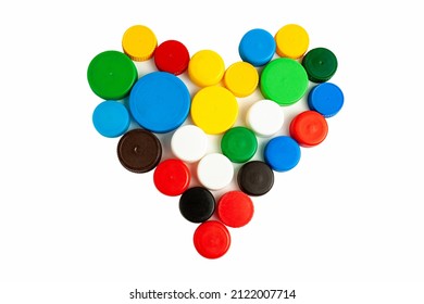 Colored screw caps for plastic bottles used to seal plastic bottles on a white background. Used bottle caps in the shape of a heart collected for plastic recycling. Separate waste sorting. - Shutterstock ID 2122007714